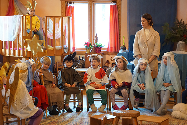 Kindergarteners seated in a line and dressed in costume for Christmas pageant 